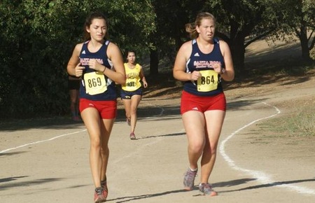 Miriam Lane (864) and Meaghan Woody (869) worked together throughout the race on the tough Woodward Park course.