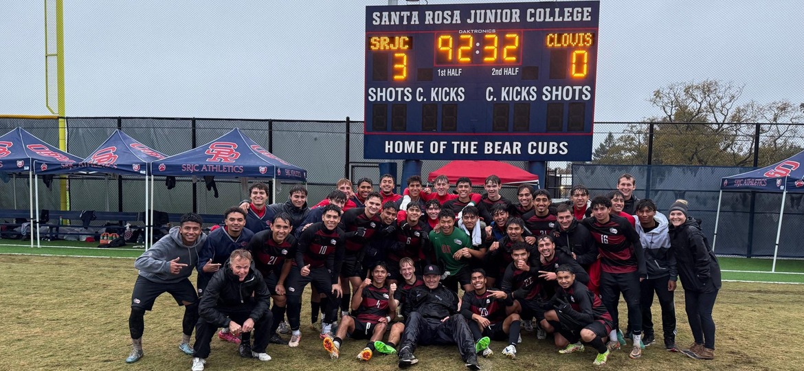 Team poses in front of scoreboard showing a final score of 3-0