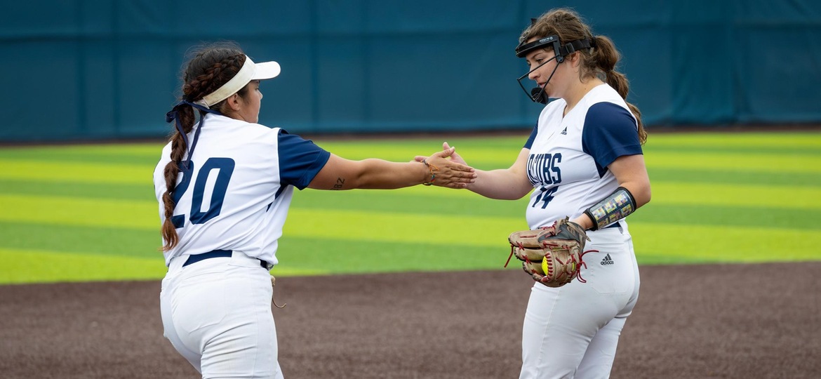 Gabby Schenone and Mya Gonzalez high five to celebrate the out.